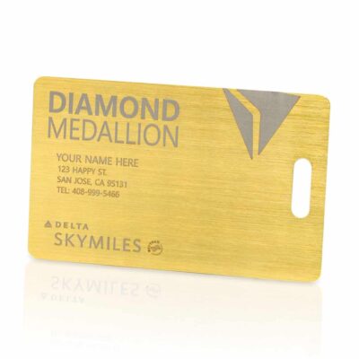 Gold diamond medalion themed business card with personalized contact info on a brushed metallic background, promoting luxury branding.